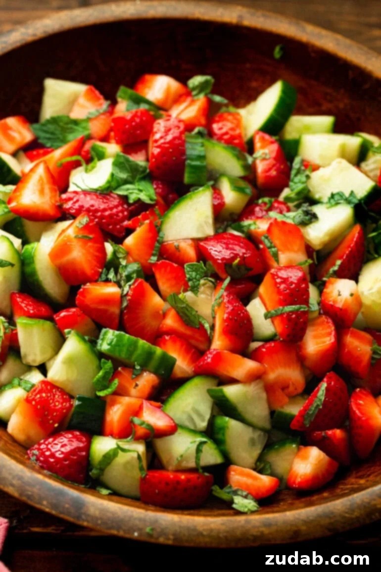 Vibrant Strawberry Cucumber Salad with Honey Balsamic 5 a photo of a cucumber strawberry salad mixed with fresh mint