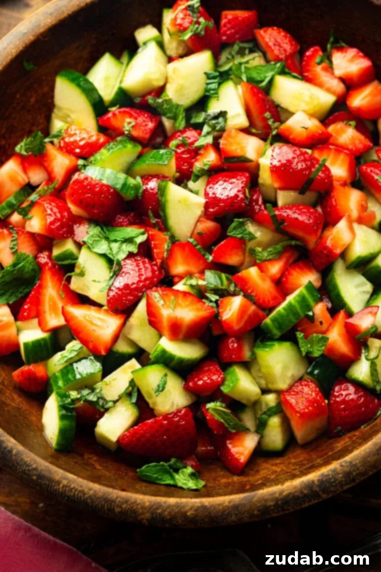 Vibrant Strawberry Cucumber Salad with Honey Balsamic 6 a photo of a large wooden mixing bowl full of strawberry cucumber salad