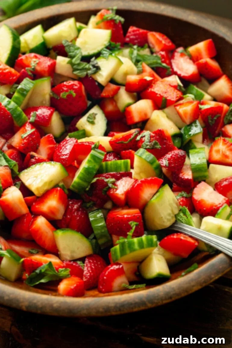 Vibrant Strawberry Cucumber Salad with Honey Balsamic 7 a photo of a cucumber and strawberry salad tossed with a honey balsamic vinegar dressing and fresh mint