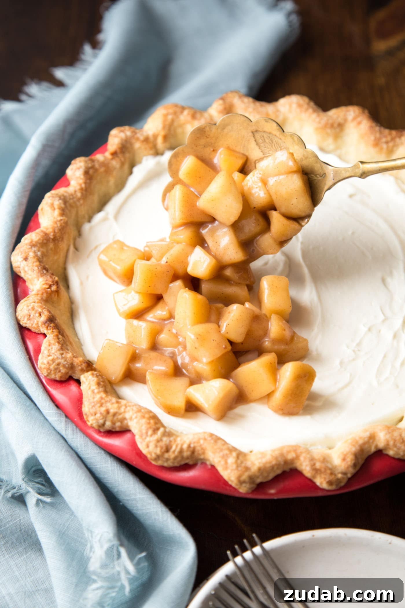 Creamy Apple Pie 4 Adding spiced apple pie filling over the creamy layer in an apple cream pie.