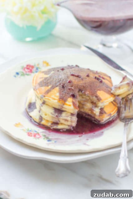 Creamy Marionberry syrup poured over a stack of pancakes, perfect for Mother's Day breakfast or any special occasion