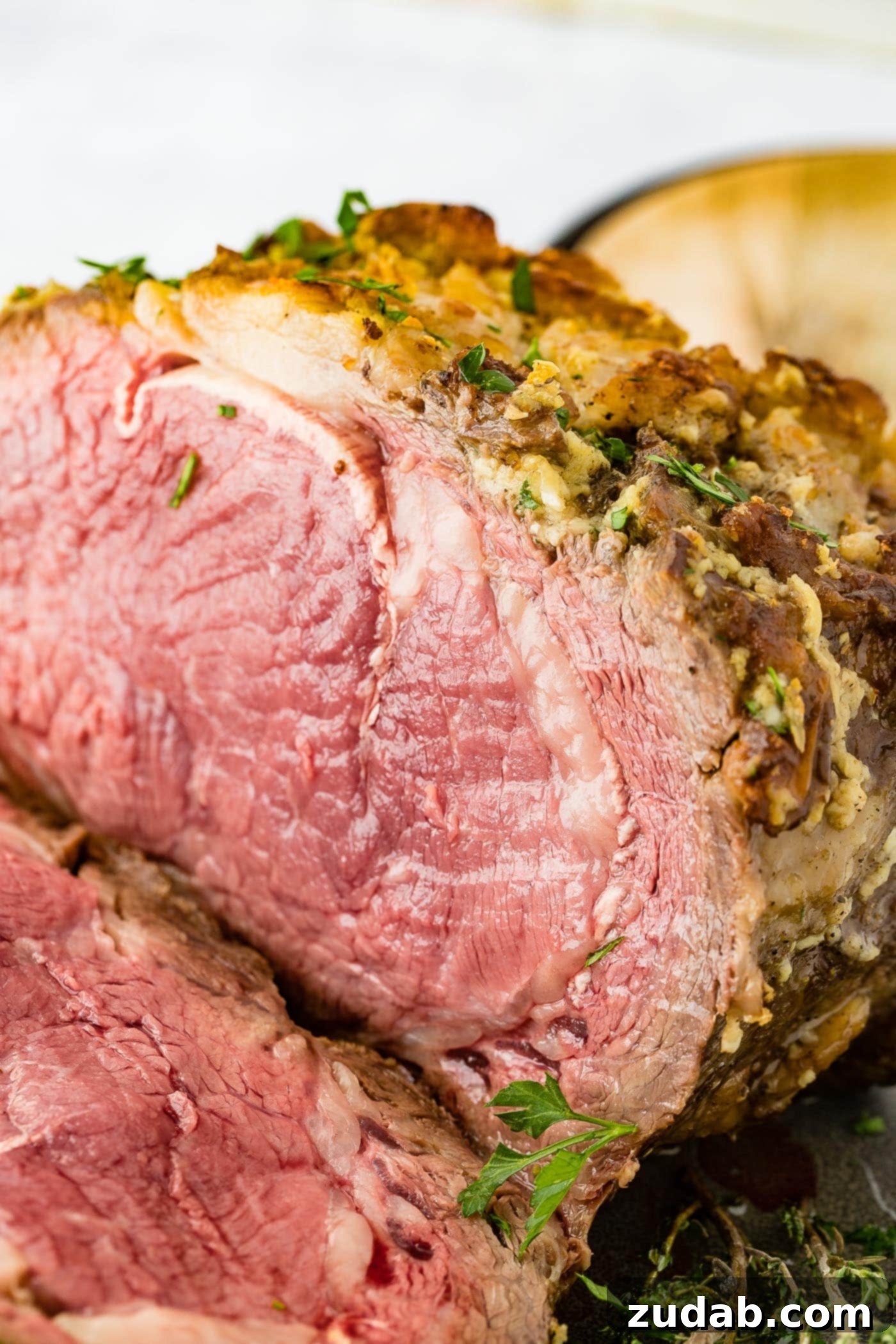 Perfect Instant Pot Prime Rib 2 A large Instant Pot Prime Rib roast, expertly sliced and ready to be served, showcasing its perfect medium-rare doneness.