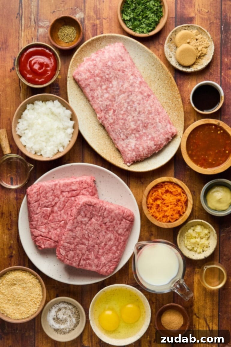 Our Favorite Classic Meatloaf 3 A selection of fresh meatloaf ingredients laid out, including ground meats, eggs, vegetables, and herbs, ready for preparation.