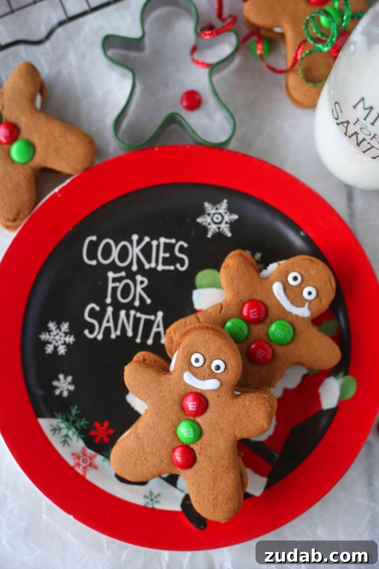 Gingerbread Men Creme Delights 4 Assortment of traditional metal holiday cookie cutters including a gingerbread man, Christmas tree, and star shapes, laid out on a rustic wooden surface, symbolizing creative baking options.