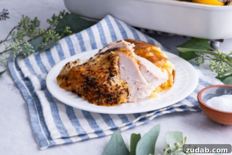 The Ultimate Golden Oven Roasted Thanksgiving Turkey 3 a photo of a large white platter topped with juicy roasted turkey pieces