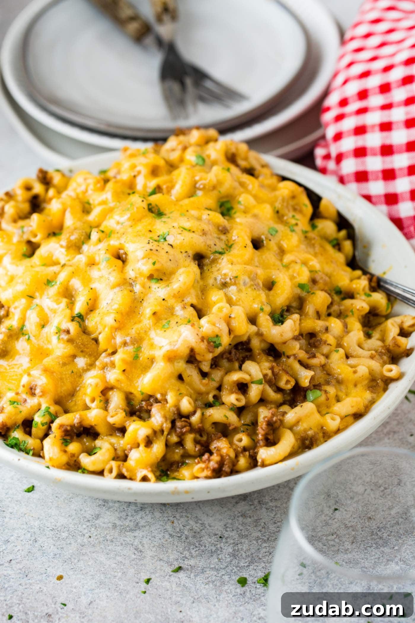 Instant Pot Hamburger Helper A vibrant close-up photo of a white serving bowl filled with cheesy Instant Pot Hamburger Helper, ready to be enjoyed.