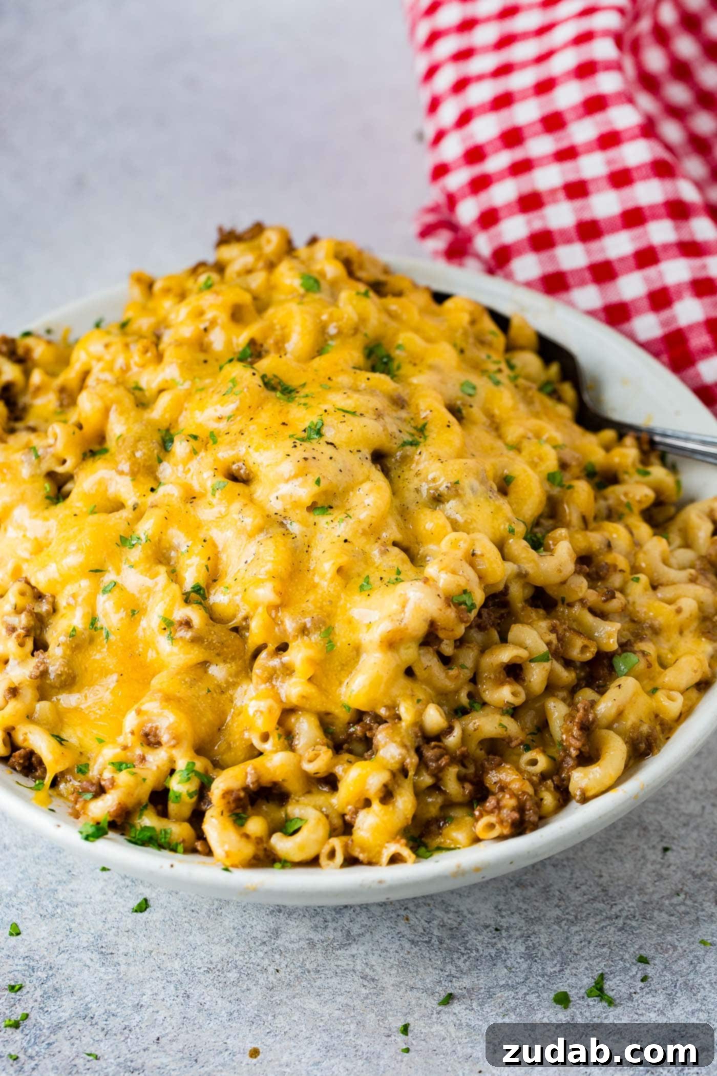 Instant Pot Hamburger Helper A full white serving bowl of creamy, cheesy Instant Pot Hamburger Helper, garnished slightly, inviting a satisfying meal.