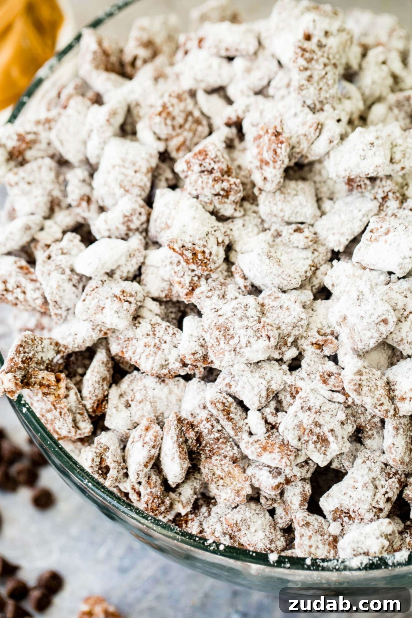 Chex Puppy Chow Muddy Buddies Mix A photo of muddy buddies snack mix in a glass bowl.