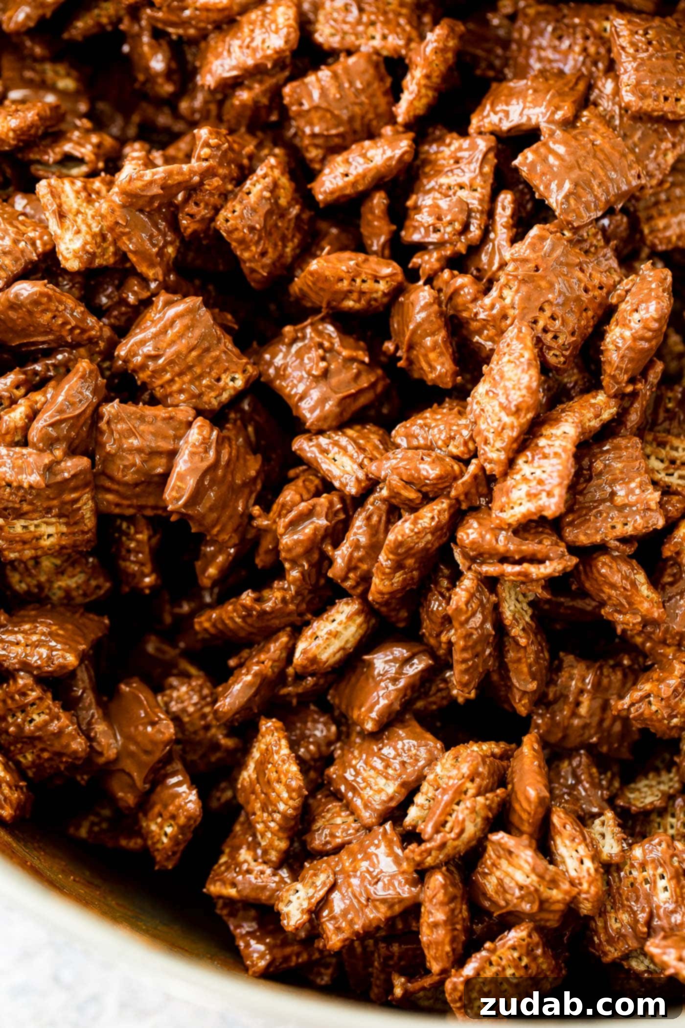 Chex Puppy Chow Muddy Buddies Mix A photo of rice Chex coated in melted chocolate and peanut butter.