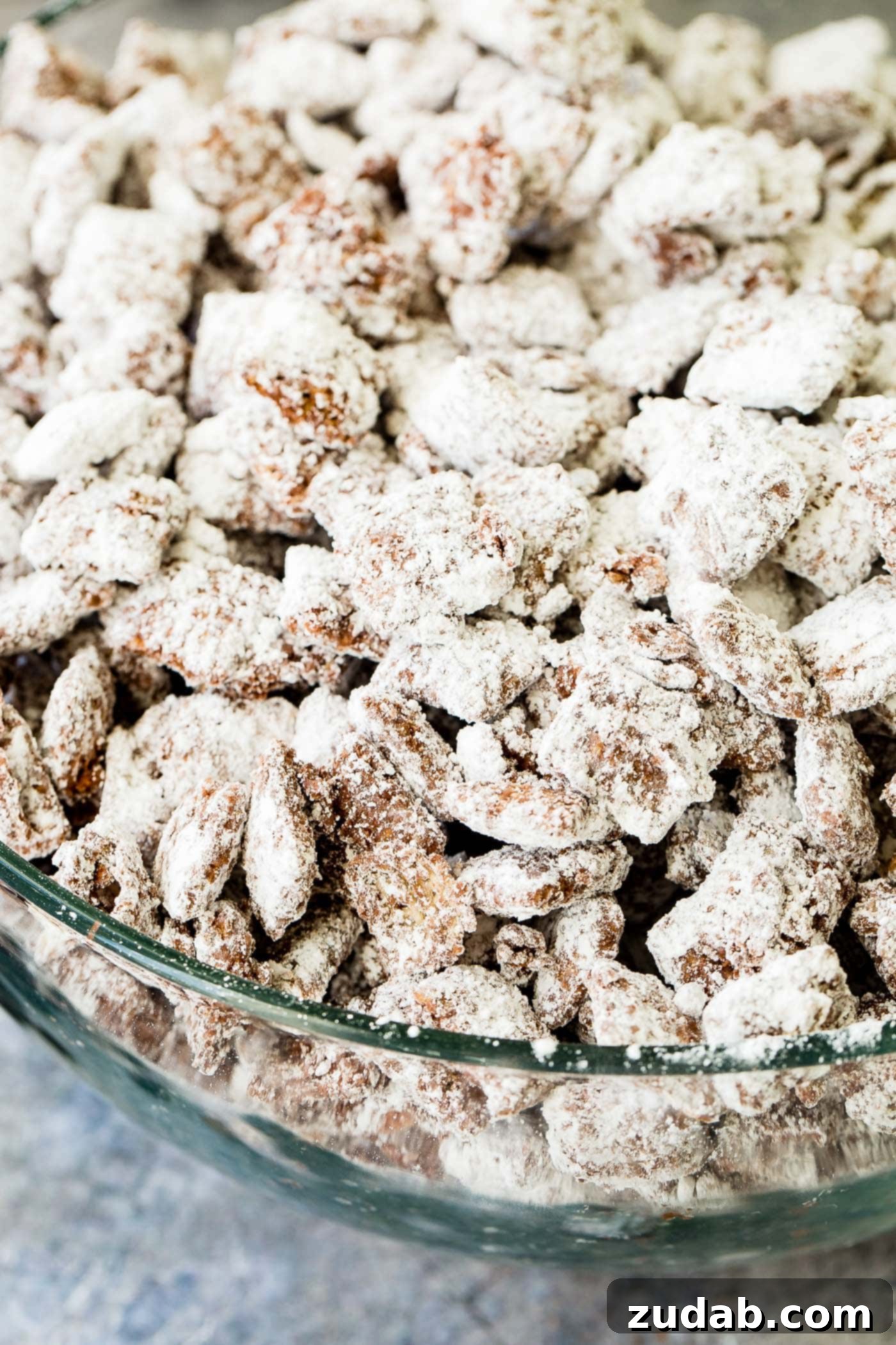 Chex Puppy Chow Muddy Buddies Mix A photo of muddy buddies snack mix in a glass bowl.
