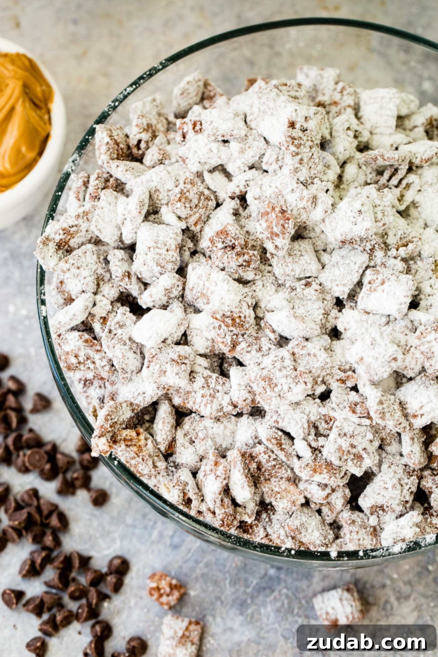 Chex Puppy Chow Muddy Buddies Mix A photo of muddy buddies snack mix in a glass bowl.