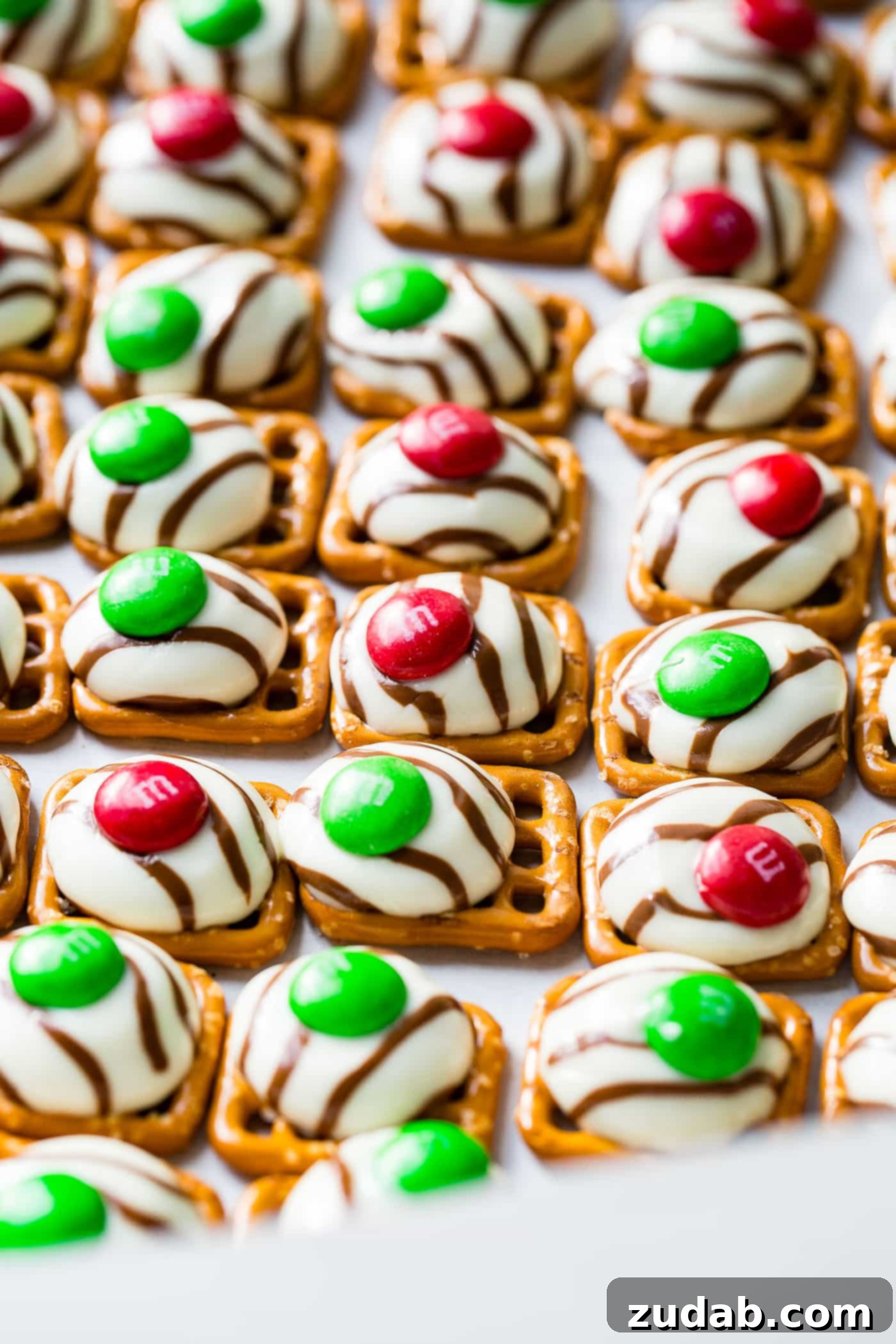 Addicting Christmas M&M Pretzel Hugs A close-up of Christmas M&M Pretzel Hugs, showing the sweet and salty texture