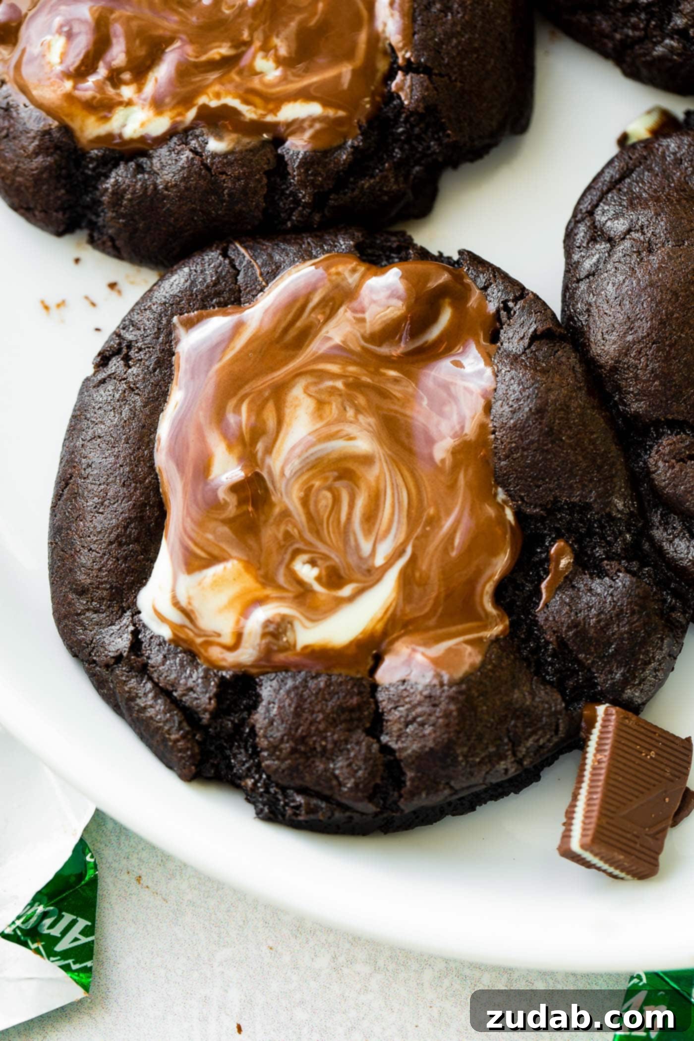 Andes Mint Chocolate Cookies A close-up photo of a rich chocolate cookie topped with a perfectly melting Andes Mint.