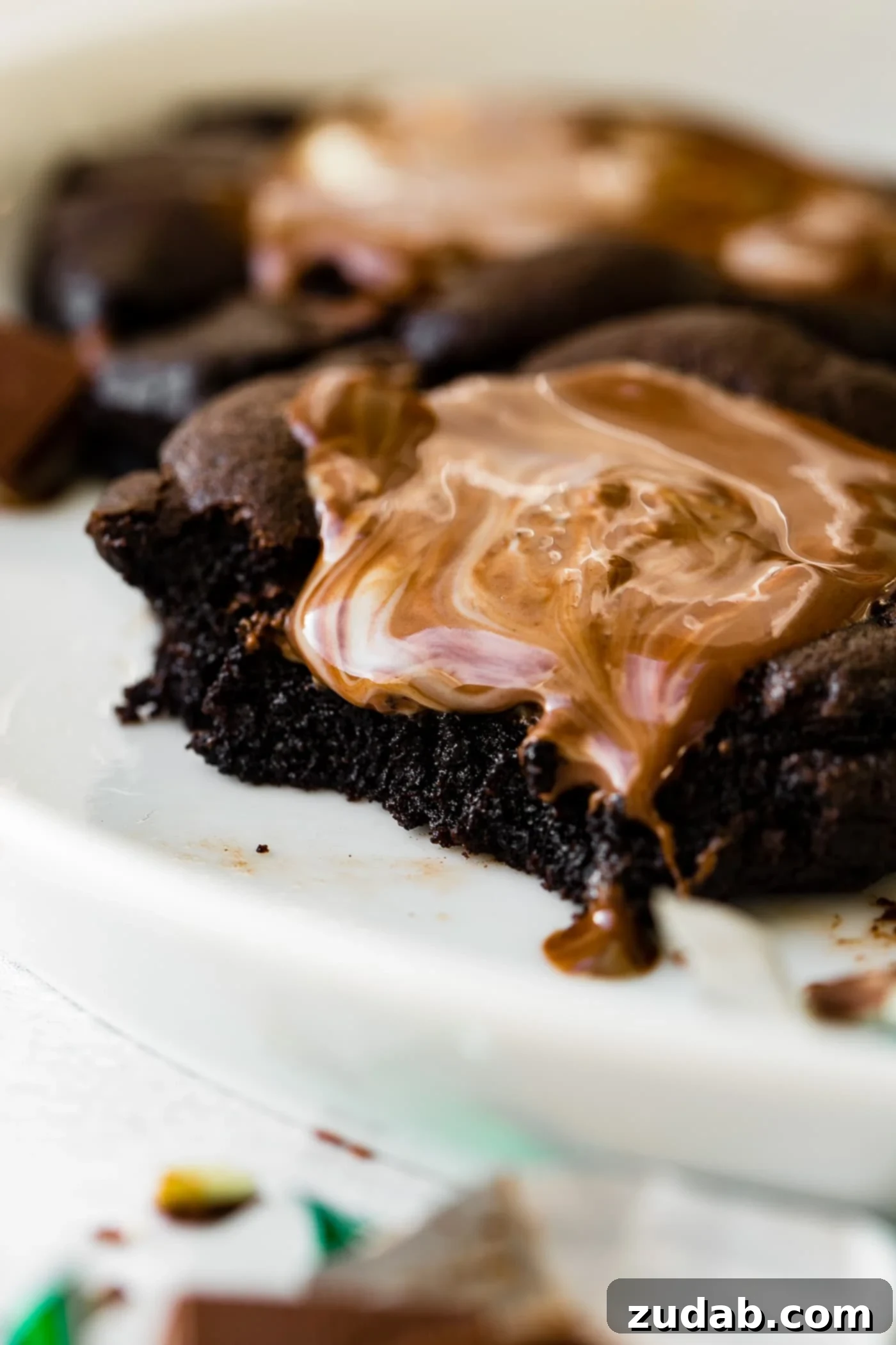 Andes Mint Chocolate Cookies A chocolate cookie with a melting Andes Mint broken in half, revealing the gooey chocolate and mint layers.