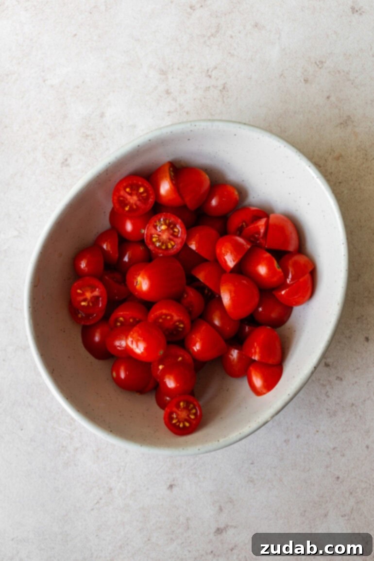 Lemon Basil Chicken Pasta 7 a photo of a bowl of grape tomatoes that have been sliced in half
