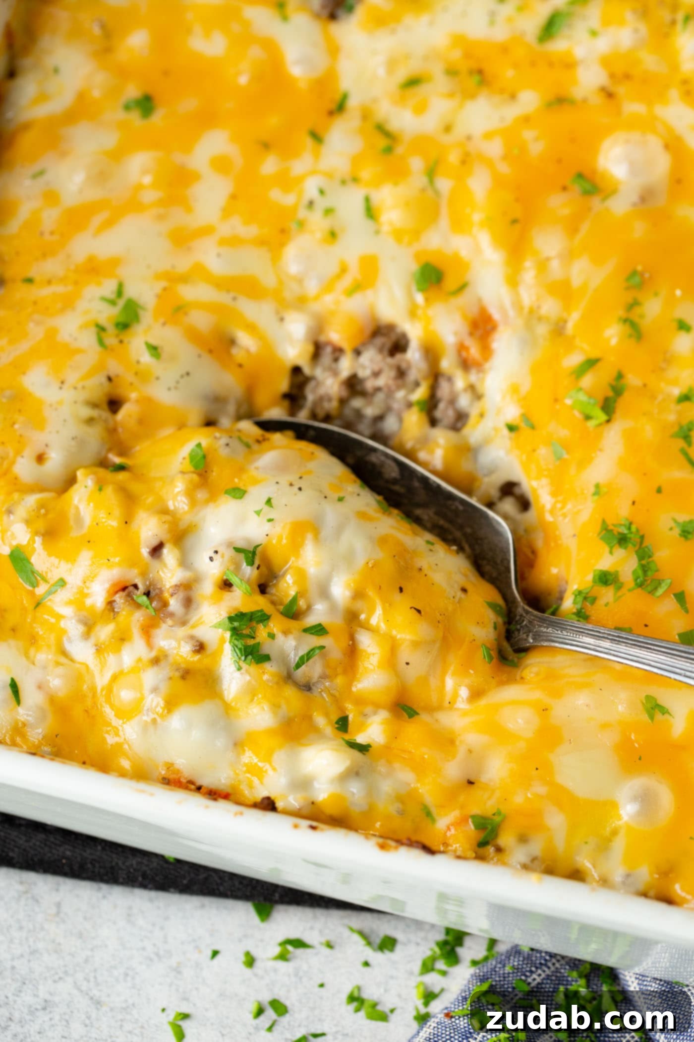 Low Carb Cheesy Ground Beef and Cauliflower Rice Casserole A photo of a baking dish full of low carb cheesy ground been and cauliflower rice casserole.