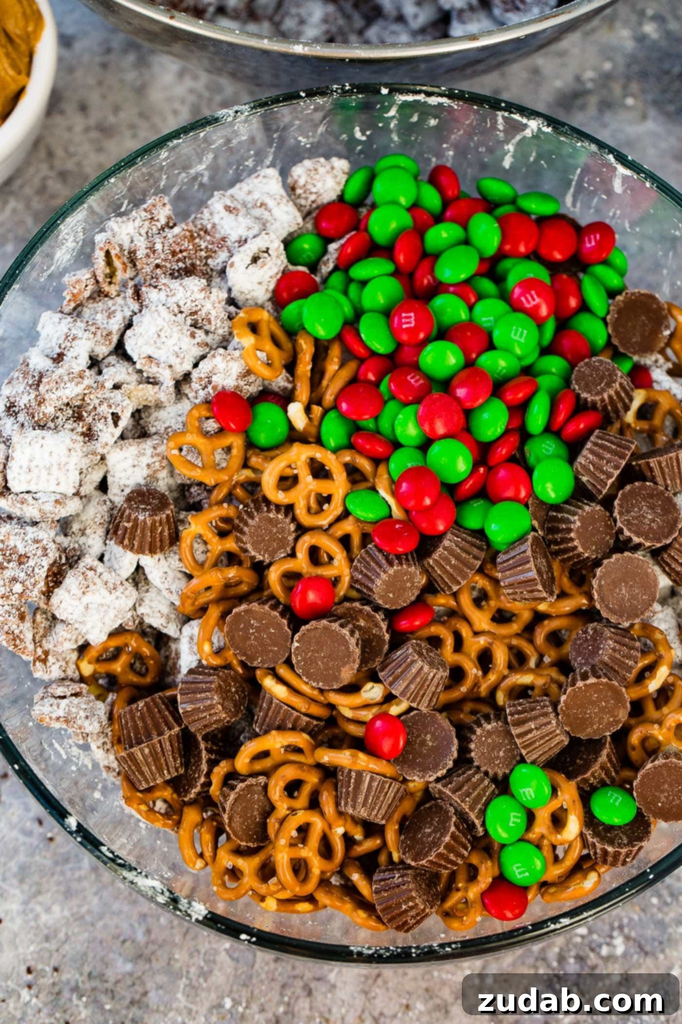 Reindeer Muddy Buddies Christmas Snack Mix Close-up of a festive Christmas snack mix, highlighting the appealing contrast of sweet and salty, creamy and crunchy elements, making it an irresistible holiday treat.