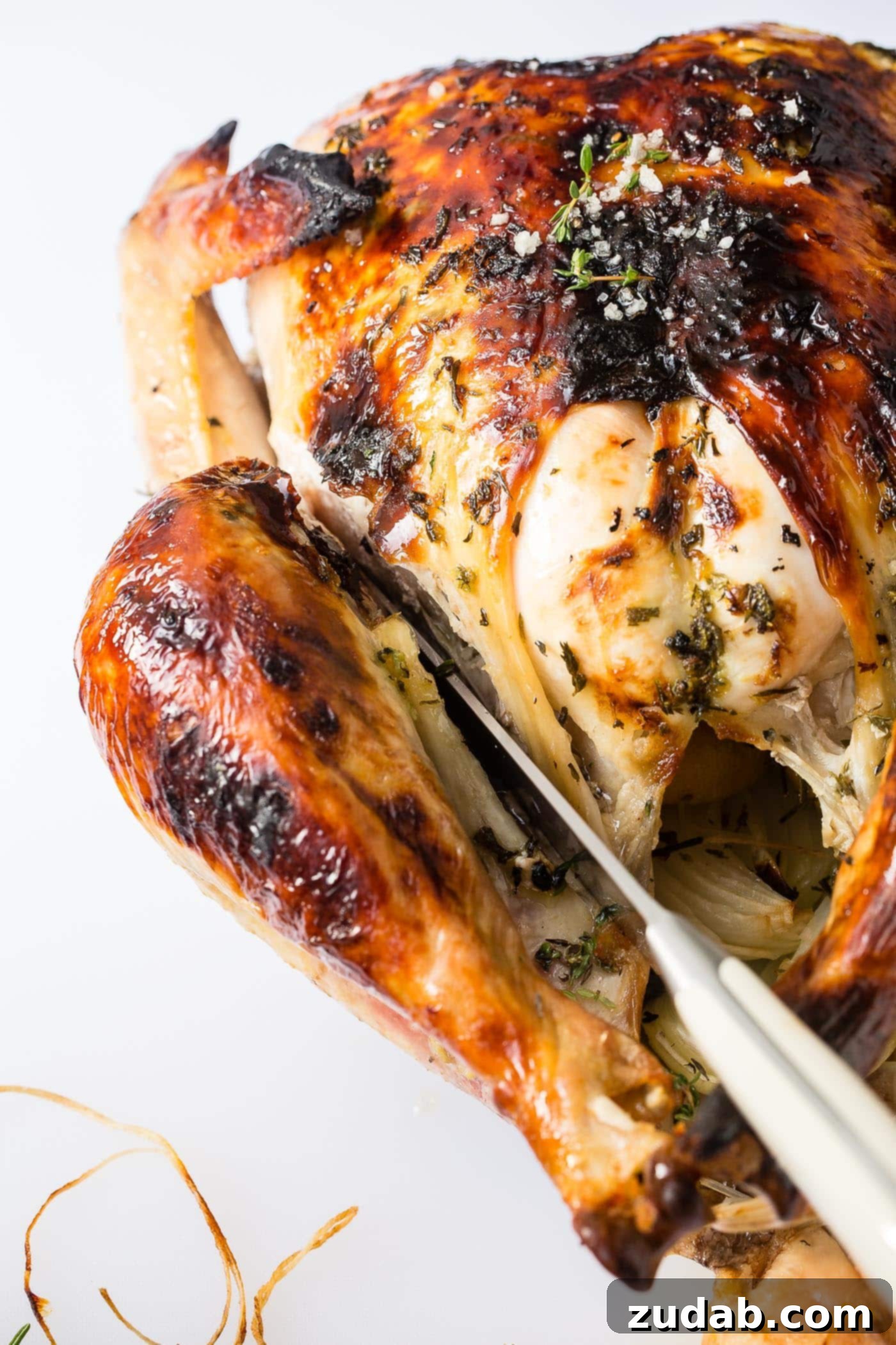 How to Carve a Turkey A photo demonstrating how to carve the leg and thigh from a whole roasted turkey by cutting through the joint.