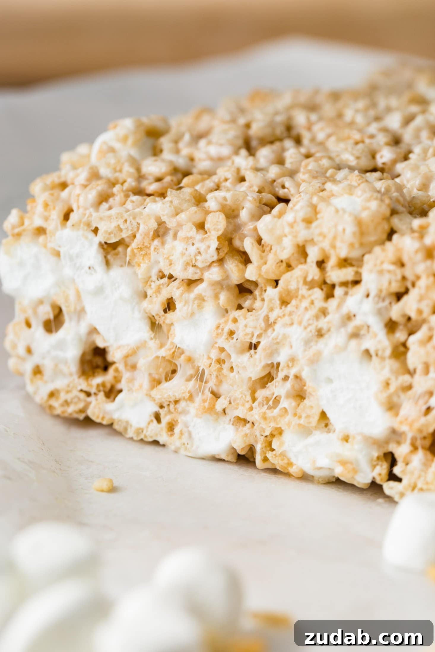 Chewy Gooey Rice Krispie Dreams 4 A piece of rice krispie treat that shows all the little marshmallows inside.