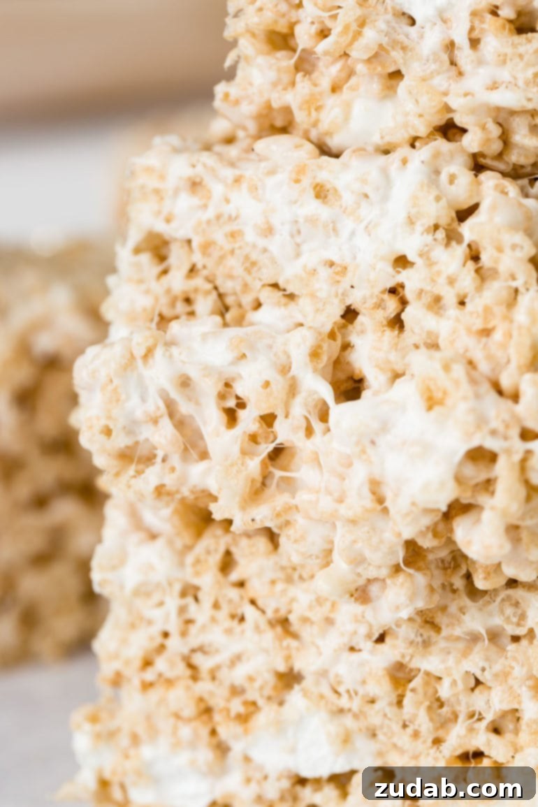 Chewy Gooey Rice Krispie Dreams 5 Three pieces of rice krispie treats, stacked up and showing the gooey melted marshmallow.n