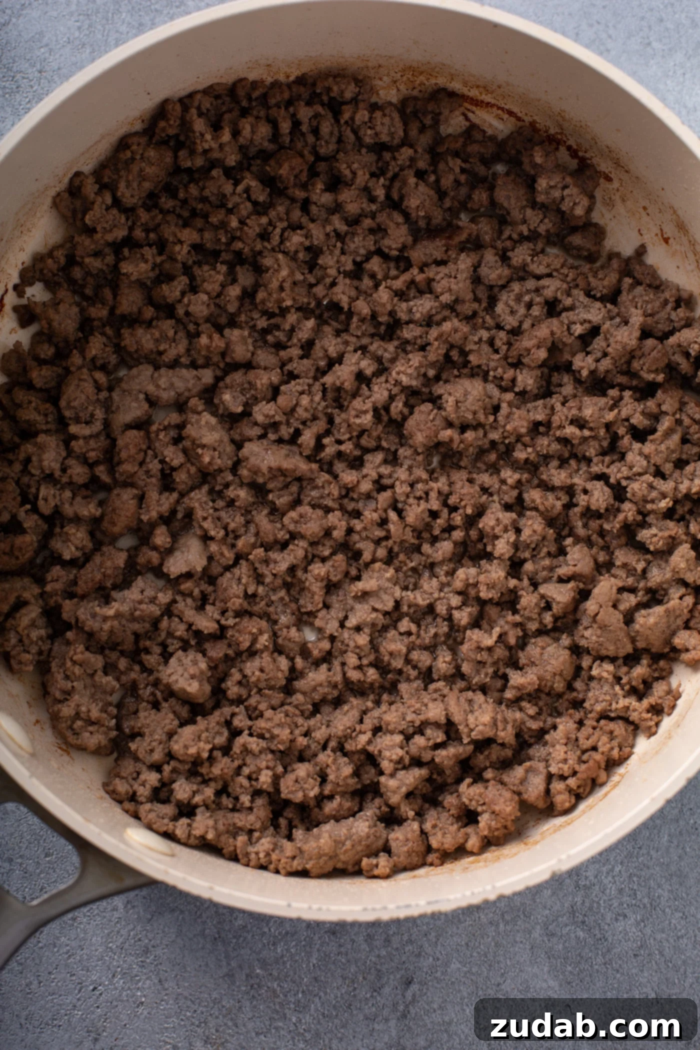 Classic Shepherd's Pie A casserole dish containing browned ground beef.