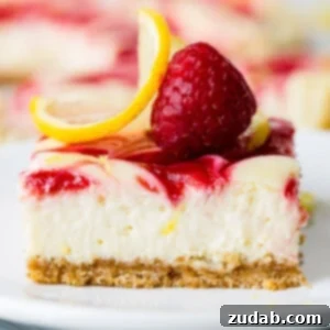 Swirled Raspberry Lemon Cheesecake Bars - a delightful blend of creamy lemon and fresh raspberry on a graham cracker crust.