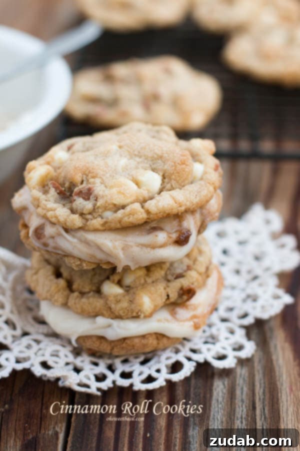 Homemade Cinnamon Roll Cookies - A Family Favorite A plate of freshly baked cinnamon roll cookies with generous frosting, inviting and warm