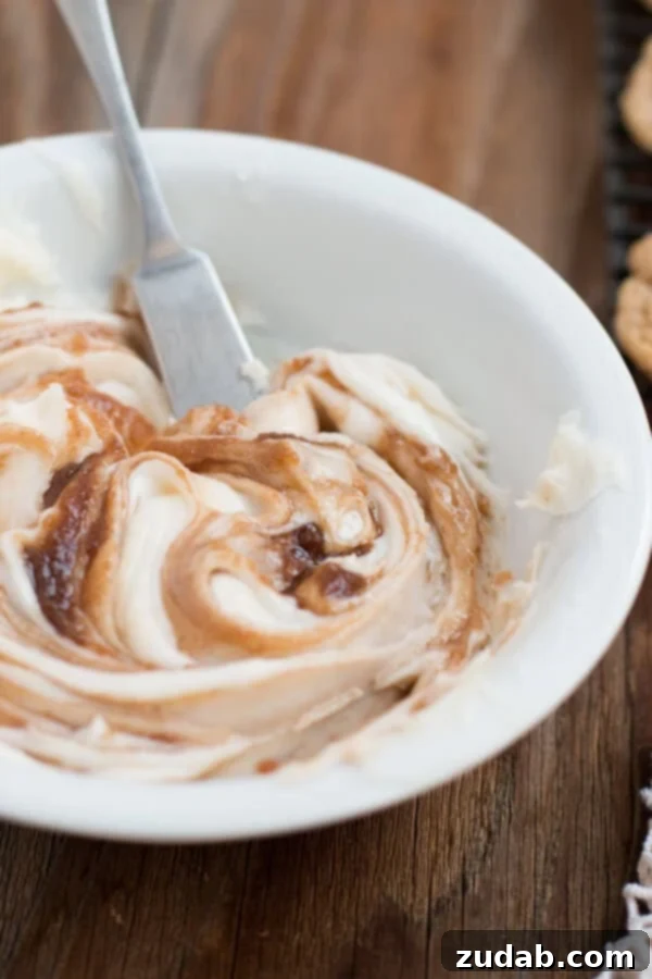 Creamy cinnamon roll frosting swirled on a dessert, rich and inviting