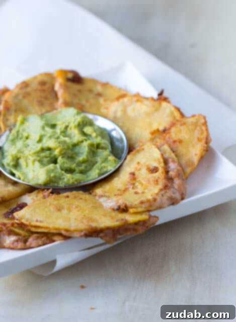 Crispy Spicy Bean and Cheese Quesadillas, perfect with fresh guacamole for Super Bowl parties
