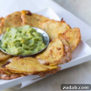 Crispy Deep Fried Bean and Cheese Quesadillas served with fresh guacamole
