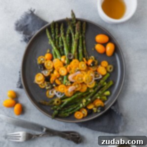 A top-down view of the Roasted Asparagus with Kumquats, showcasing the vibrant colors and fresh ingredients.