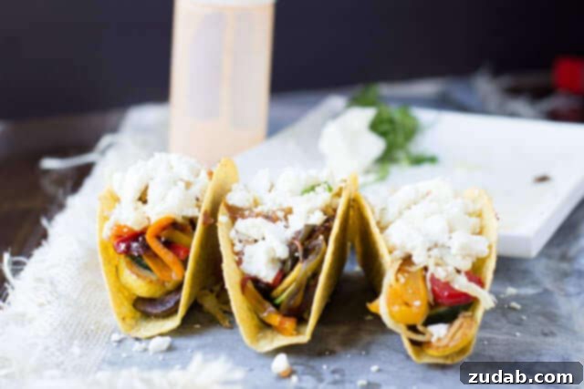 Vegetarian tacos with spicy crema. Fresh veggies sauteed and stuffed into a crunchy delicious taco topped with creamy queso fresco ohsweetbasil.com Vibrant vegetables being sautéed in a skillet for delicious vegetarian taco filling.