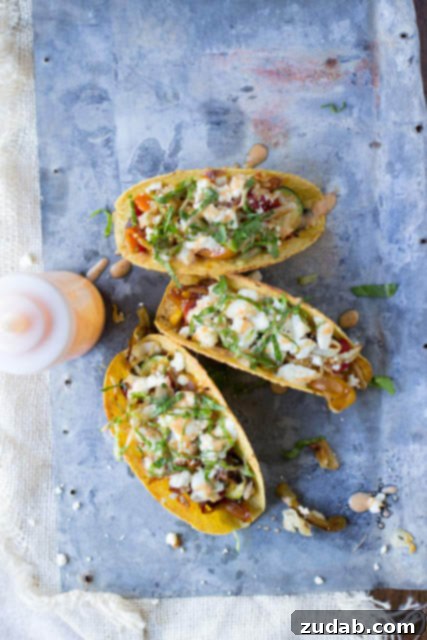 Vegetarian tacos with spicy crema. Fresh veggies sauteed and stuffed into a crunchy delicious taco topped with creamy queso fresco ohsweetbasil.com Hands preparing a vegetarian taco, showing the crispy shell, fresh vegetables, and spicy crema.