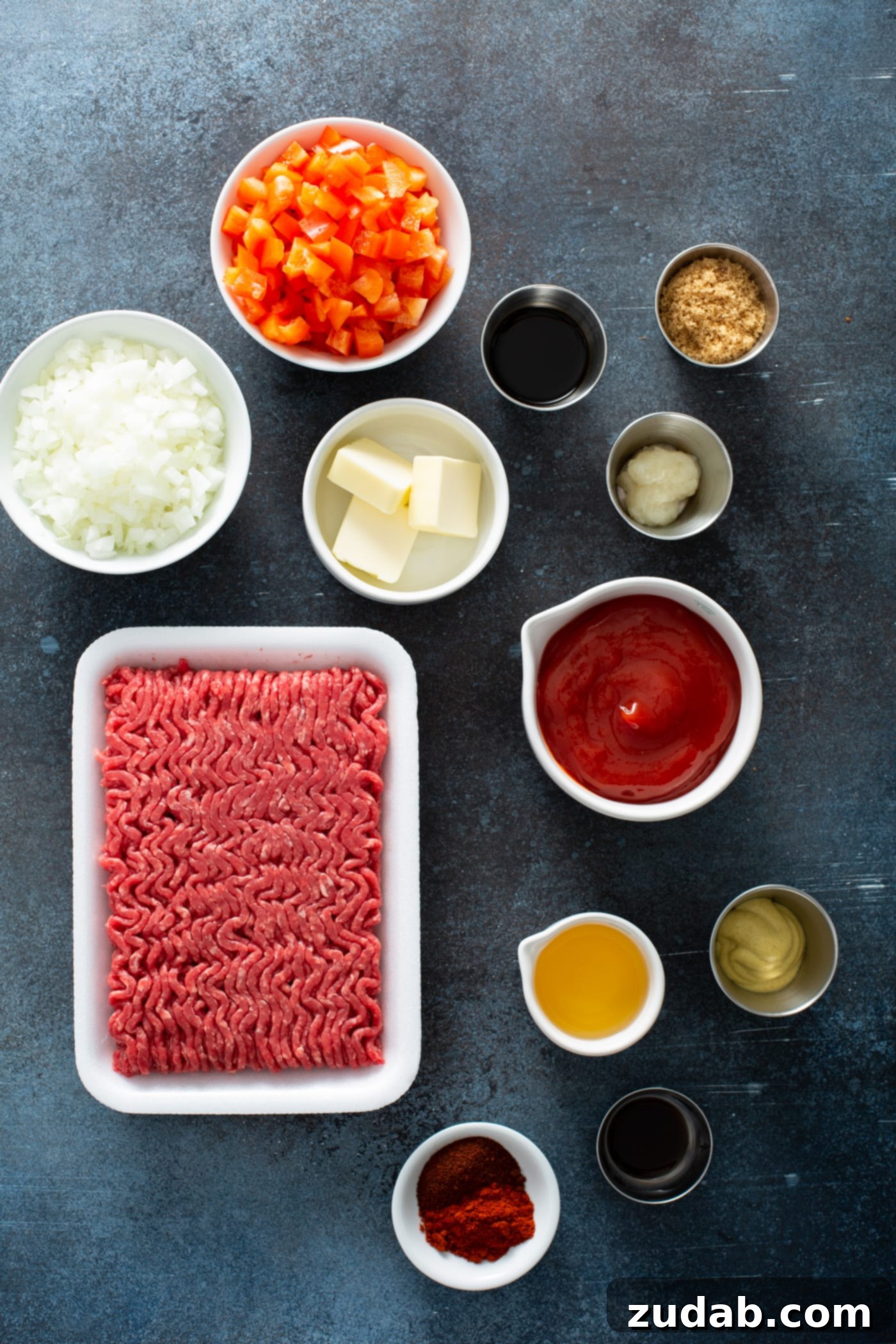 Instant Pot Sloppy Joes Ingredients Ingredients for Instant Pot sloppy joes: ground beef, dijon mustard, ketchup, butter, brown sugar, onions, chopped red bell peppers, and Worcestershire sauce in small bowls.