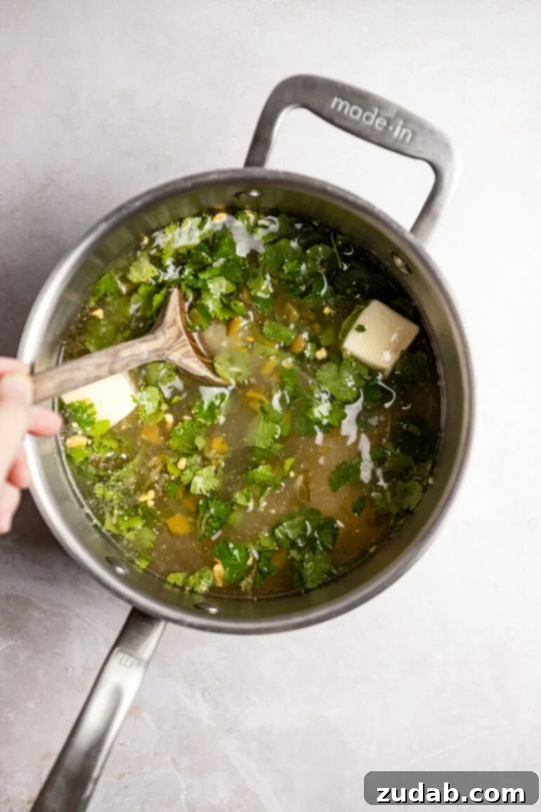 Restaurant-Quality Cilantro Lime Rice Just Like Café Rio 12 The saucepan with the rice mixture is covered with a lid and simmering on low heat, cooking to perfection.