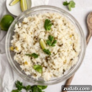 A square image depicting a bowl of Cafe Rio Cilantro Lime Rice, garnished with fresh cilantro and a lime wedge.