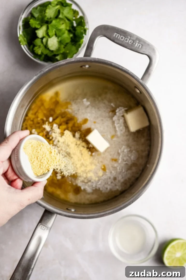 Restaurant-Quality Cilantro Lime Rice Just Like Café Rio 9 The butter and bouillon cubes are dropped into the rice mixture, ready to dissolve and add richness.