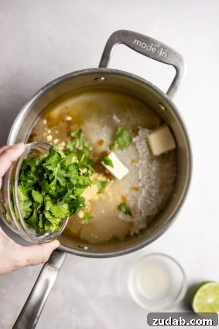 Restaurant-Quality Cilantro Lime Rice Just Like Café Rio 10 Lime juice is squeezed directly into the saucepan, adding a fresh, zesty tang to the rice mixture.