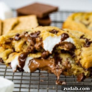 Ultimate S'mores Chocolate Chip Cookies 2 A freshly baked S'mores Stuffed Chocolate Chip Cookie on a cooling rack.