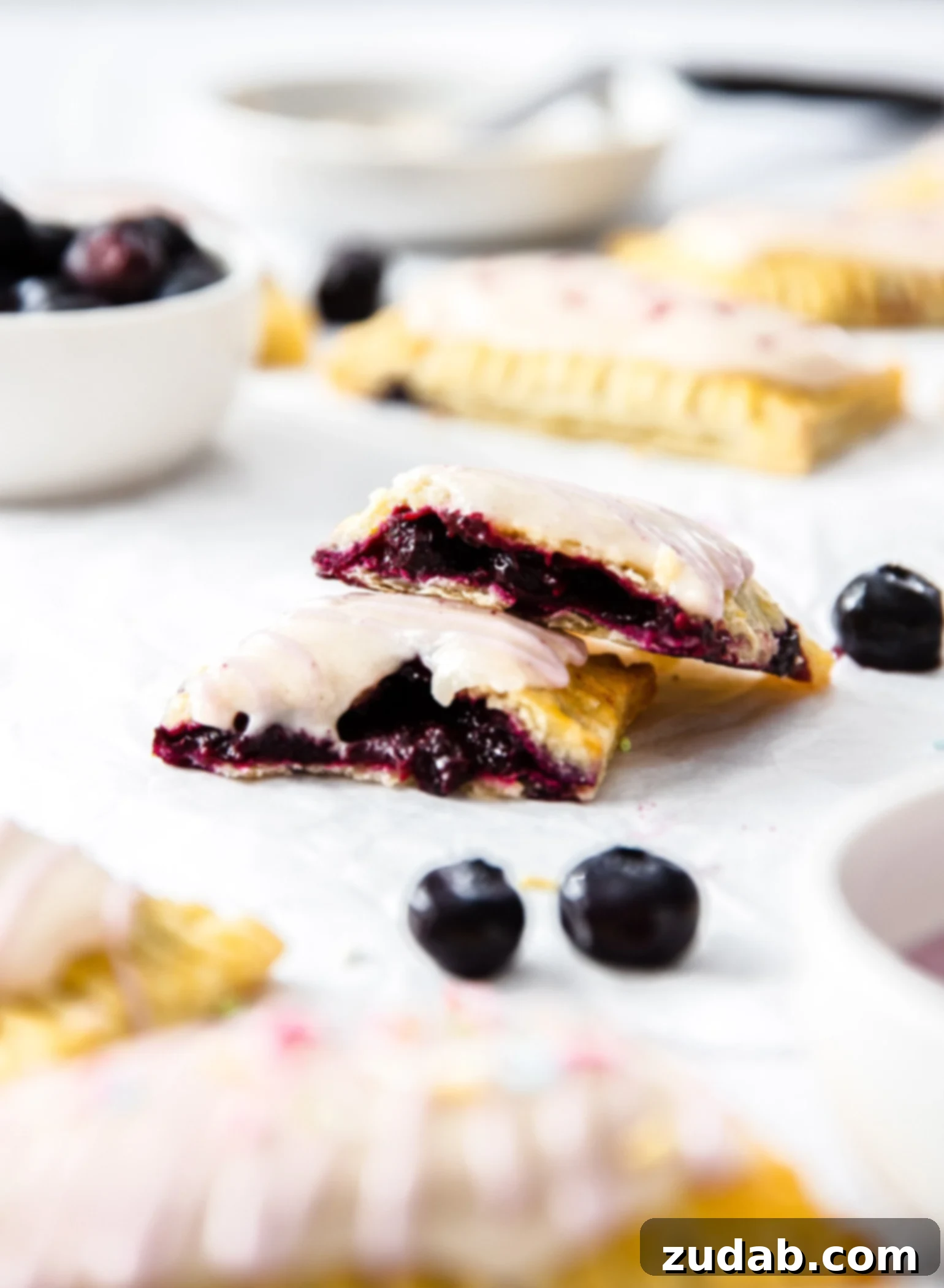 DIY Blueberry Toaster Pastries 3 A blueberry pop tart that's been broken in half showing the rich purple filling