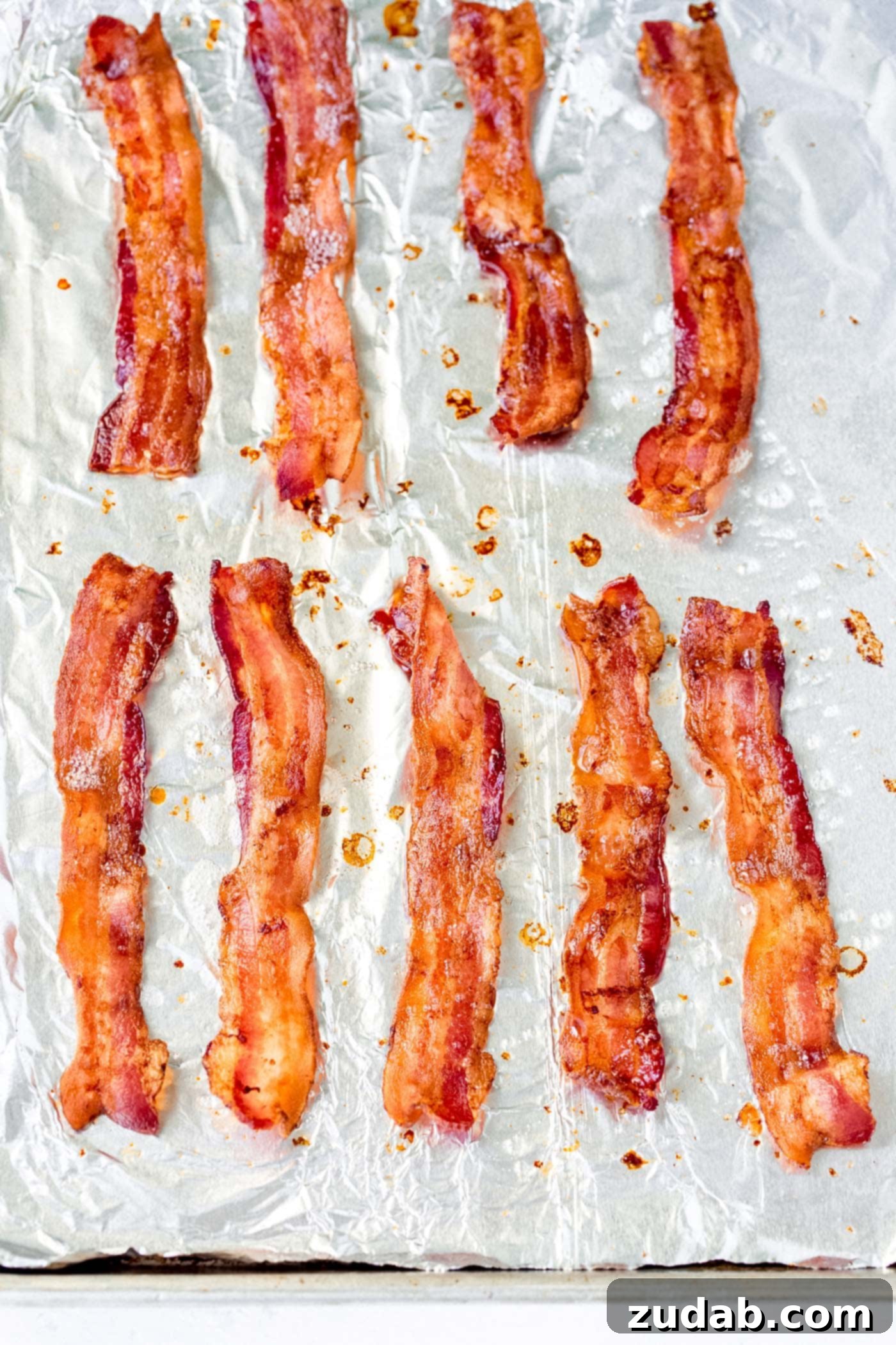 Mastering the Art of Perfect Bacon 2 Perfectly crisp bacon on a baking tray lined with foil.