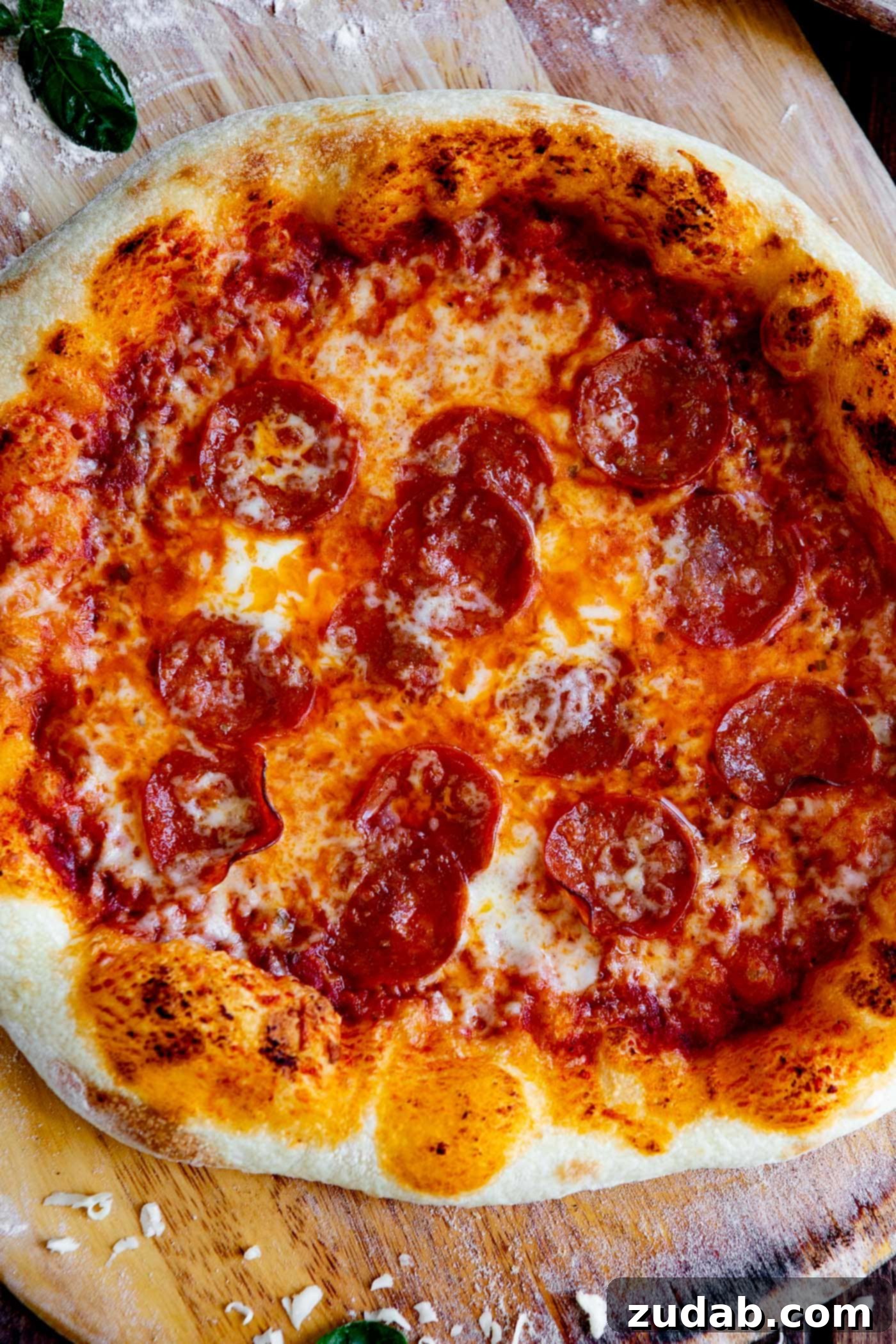 A sizzling pepperoni pizza with a perfectly charred, homemade crust, glistening sauce, and melted cheese, fresh out of the oven.