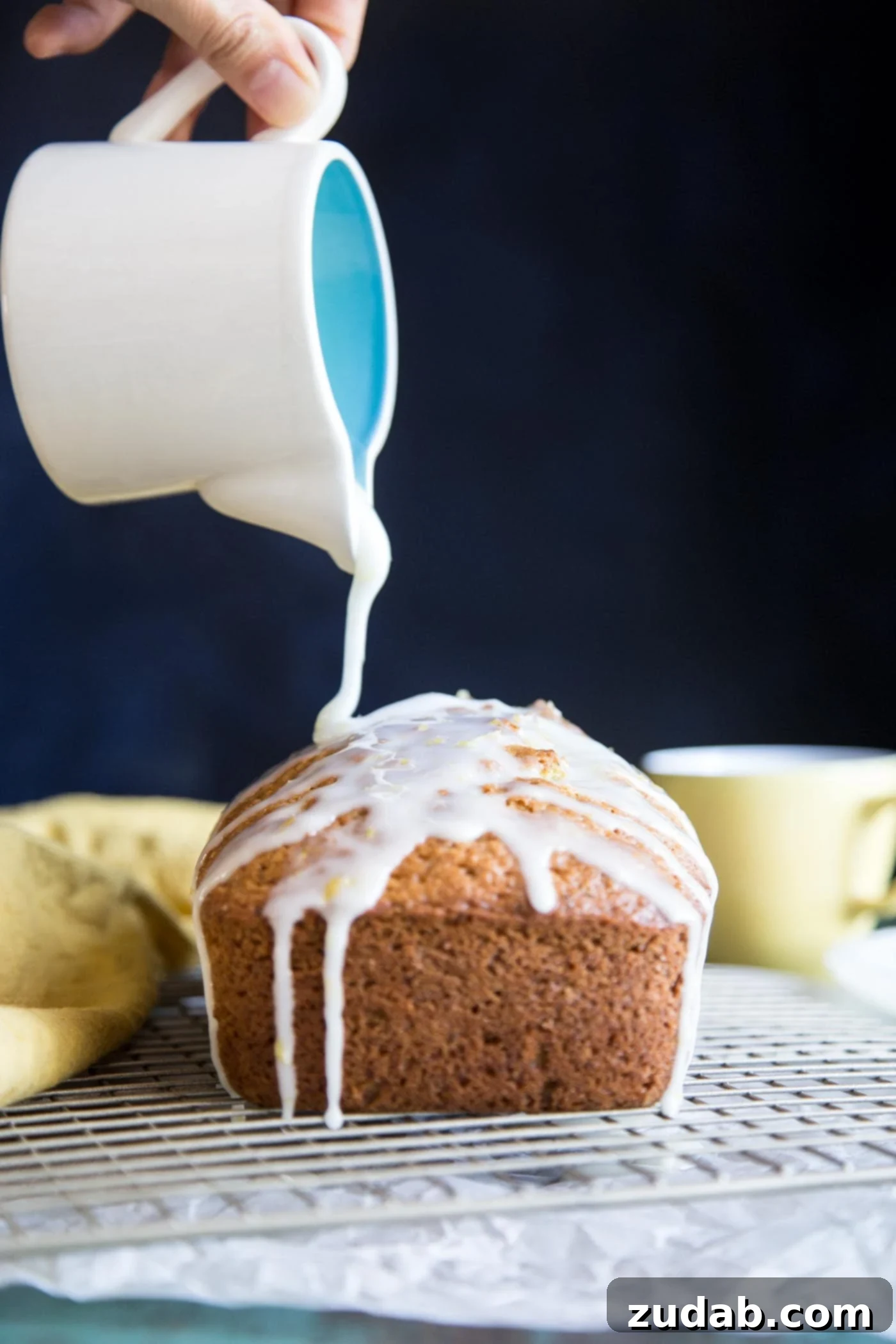 Zesty Lemon Zucchini Loaf 4 Pouring fresh lemon glaze over a perfectly baked Lemon Zucchini Bread.