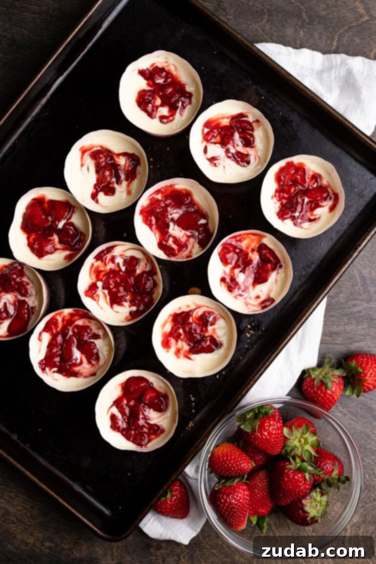 Luscious Strawberry Cheesecake Minis 4 Individual cups of cheesecake batter with a bright strawberry swirl.