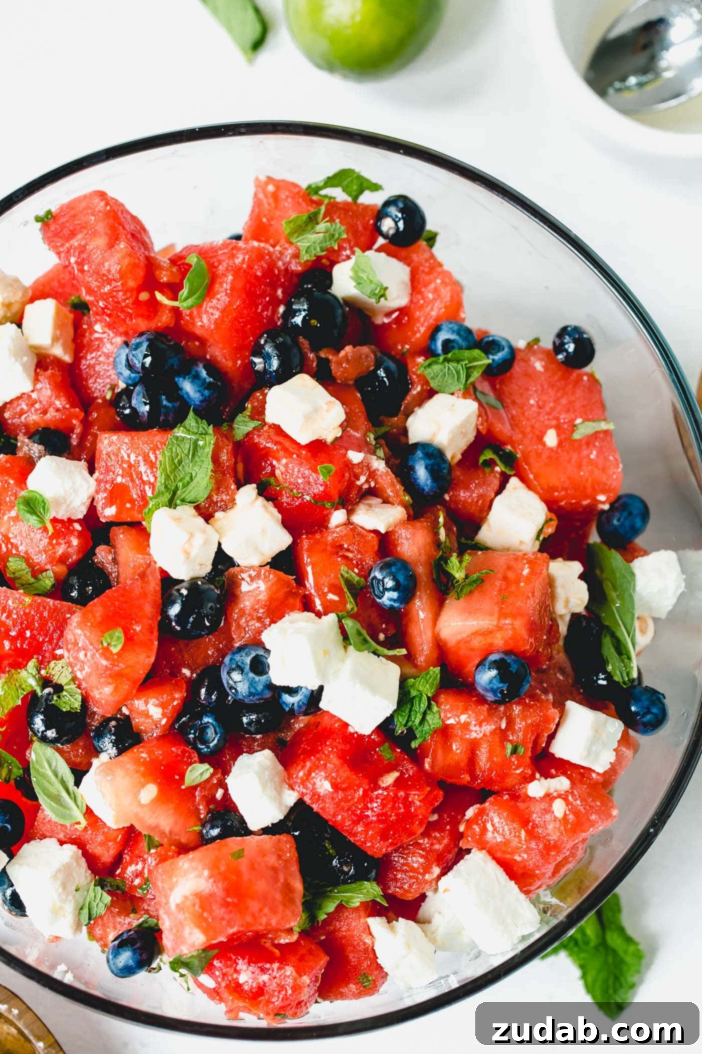 Blueberry Feta Watermelon Salad A dish of blueberry feta watermelon salad. There are bright blueberries, chunks of watermelon, and cubes of feta cheese mixed together with basil and mint leaves.