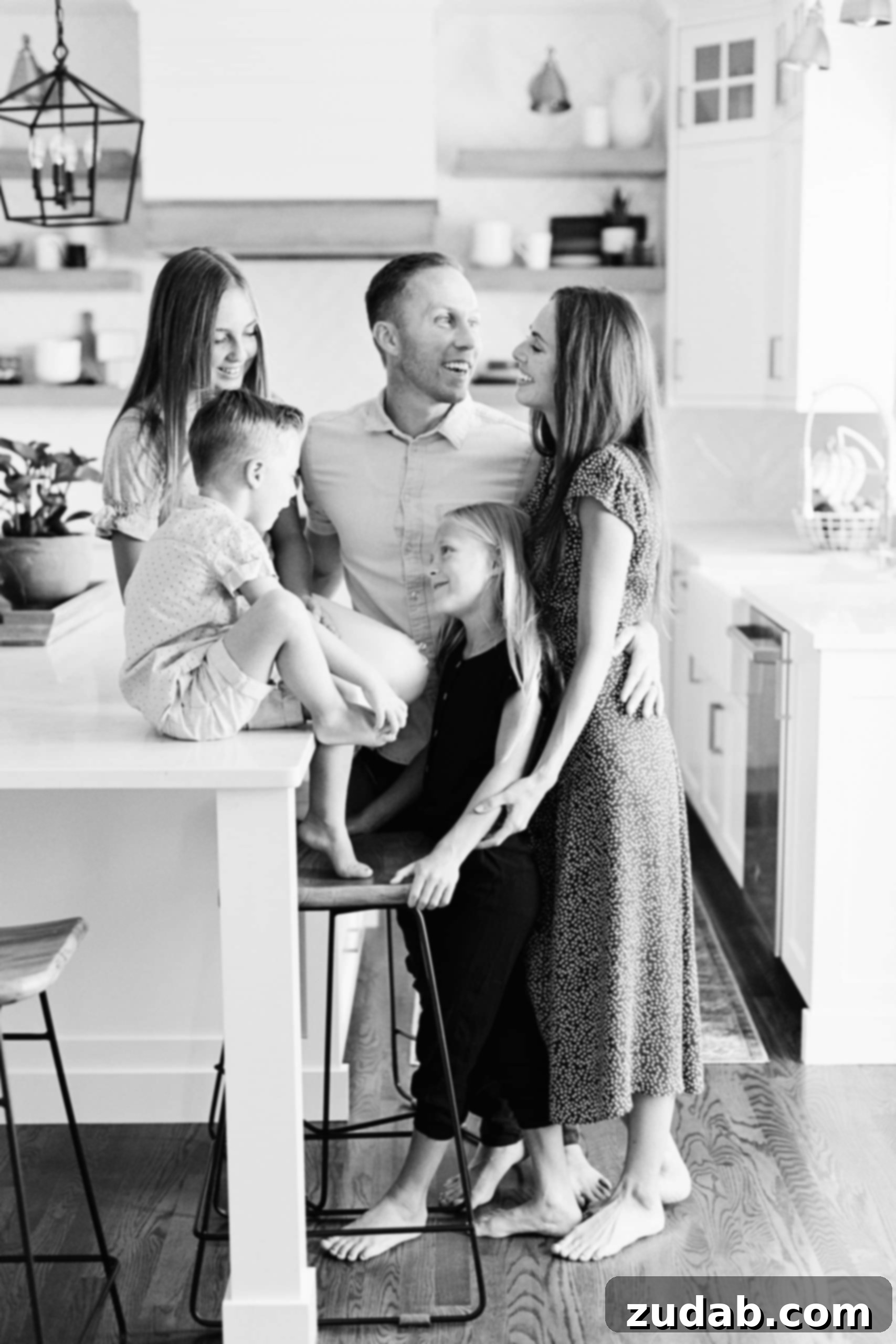 Protecting Our Family: Fighting for Values in a Digital World A happy family gathered in a bright, modern kitchen, smiling and interacting. The image promotes family togetherness and safety.