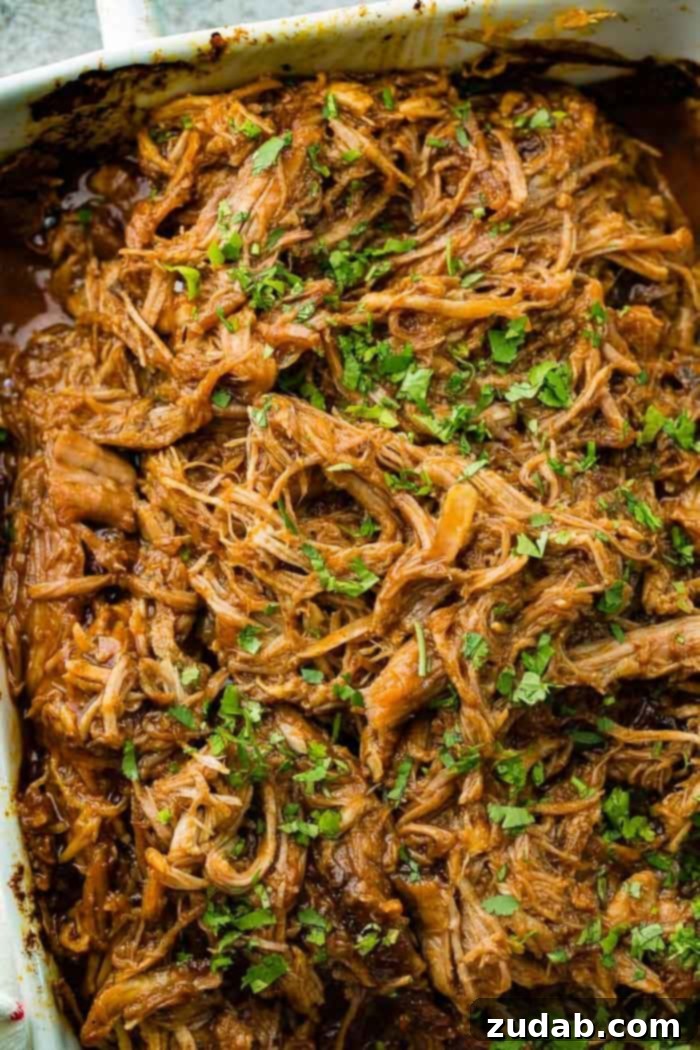 A close-up shot of the succulent shredded Cafe Rio Sweet Pork copycat recipe, generously sprinkled with fresh cilantro, inviting you to savor its authentic flavor.