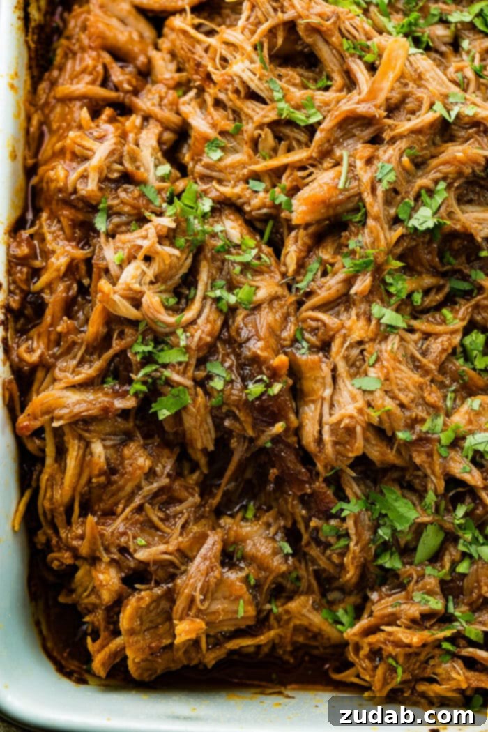 A savory platter of shredded Cafe Rio Sweet Pork, artfully arranged and garnished with fresh cilantro, ready to elevate any meal to a culinary delight.