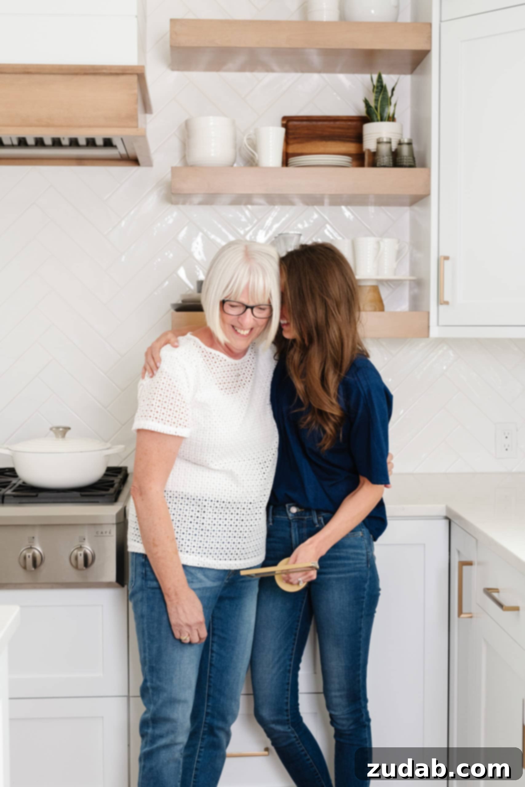 I'm a Hugger A photo of a mom and daughter hugging in the kitchen.
