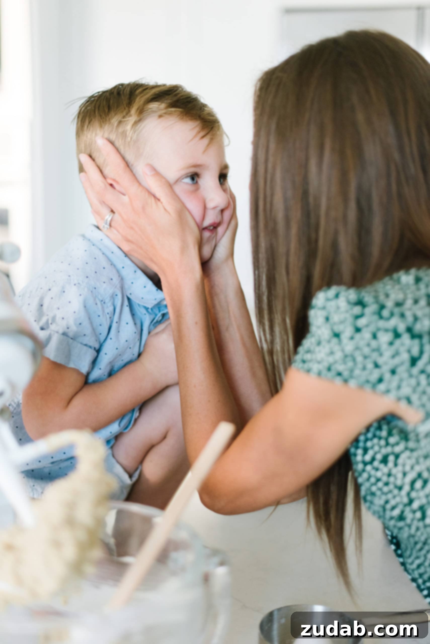 Being Present A photo of a mom holding the face of her son and looking right into his eyes.